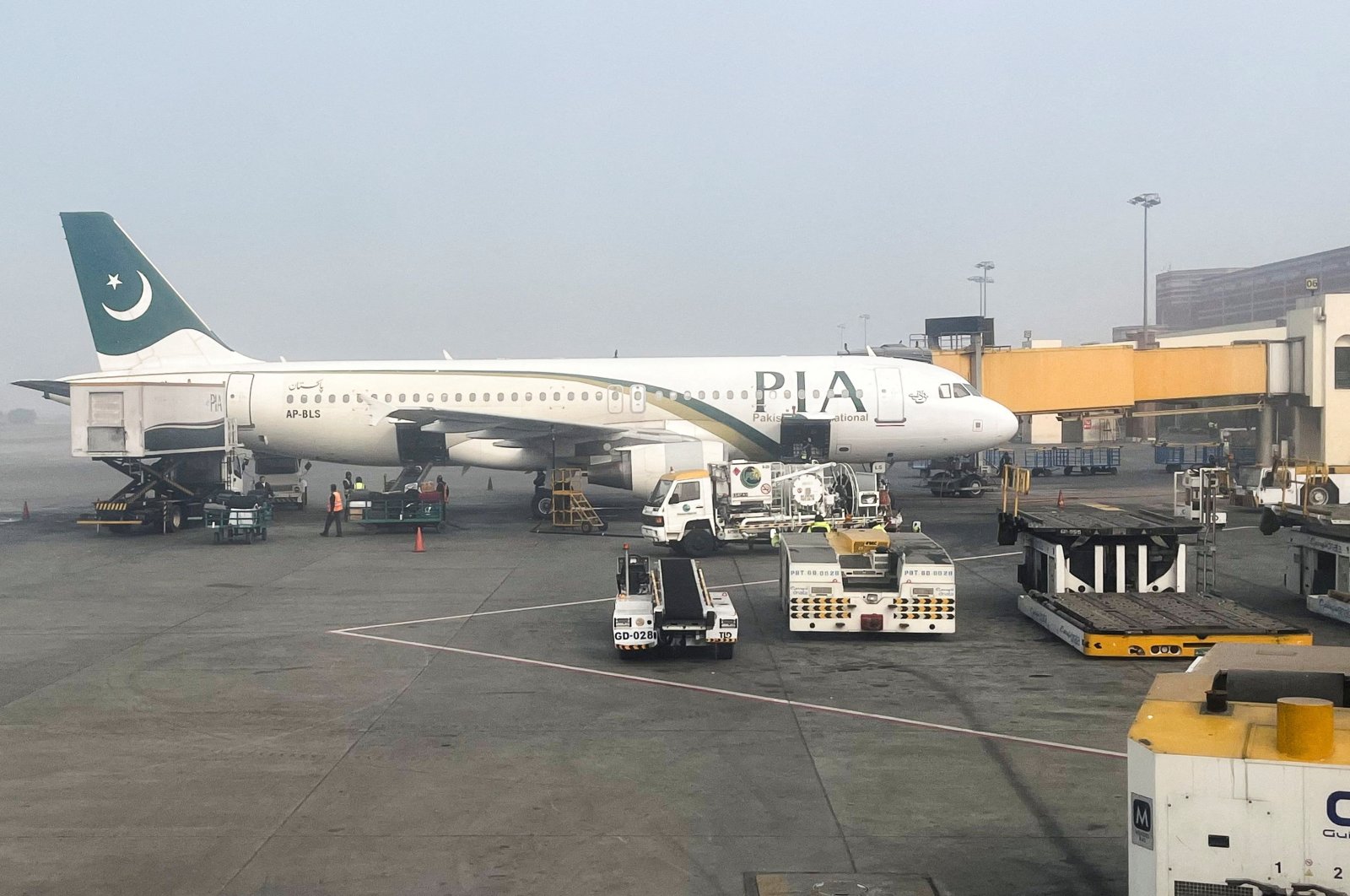 A view of a Pakistan International Airlines (PIA) passenger plane, taken through a glass panel, at the Allama Iqbal International Airport, Lahore, Pakistan Jan. 29, 2024. (Reuters Photo)