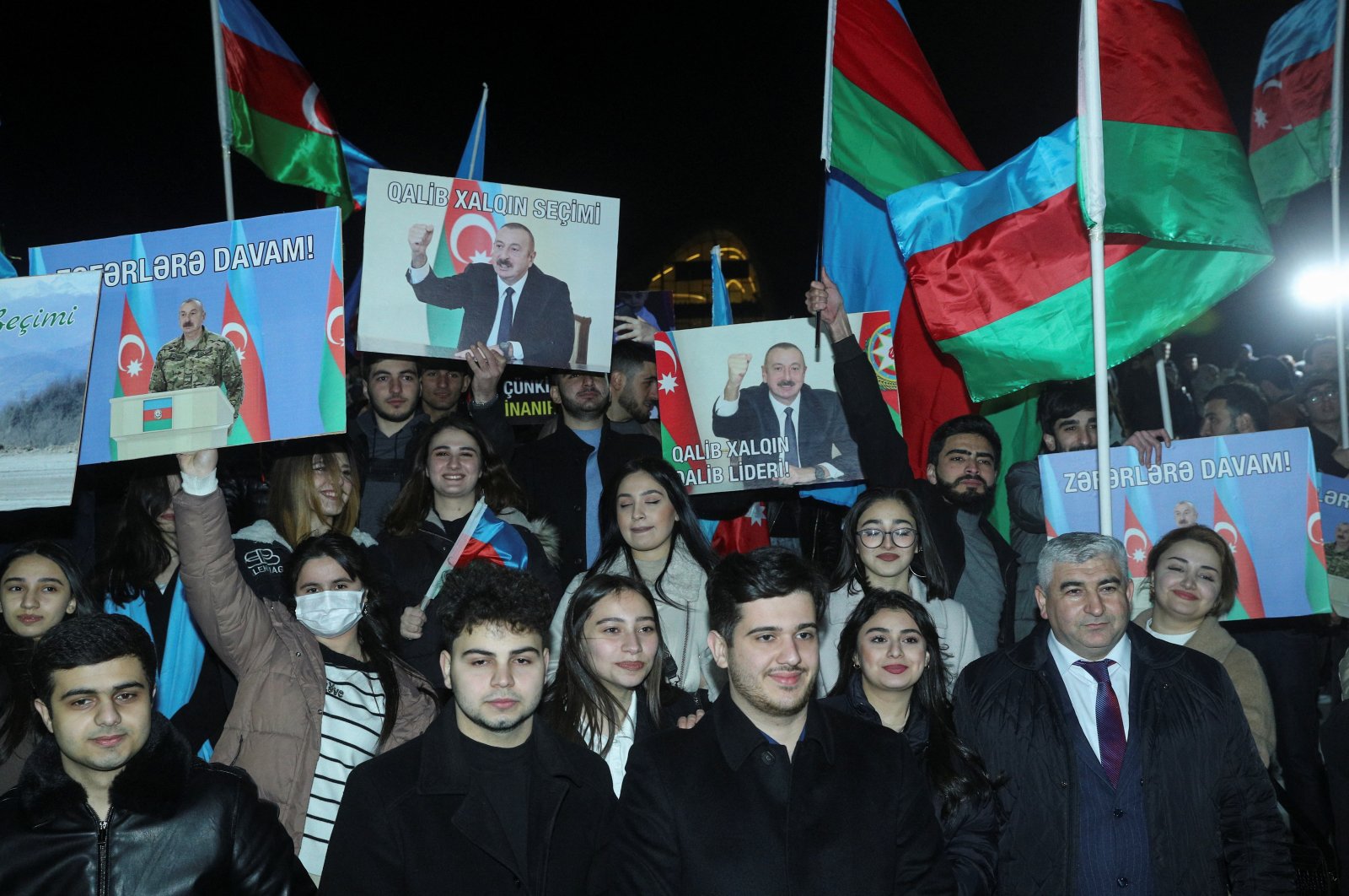Supporters of Ilham Aliyev, Azerbaijan&amp;#039;s incumbent President and a candidate for the Azerbaijani presidential elections, celebrate in a street following the announcement of exit poll results in Baku, Azerbaijan, Feb. 7, 2024. (Reuters Photo)