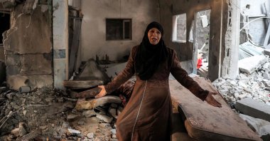 A Palestinian woman cries as she inspects a heavily damaged apartment following Israeli bombardment on Rafah, southern Gaza, Palestine, Feb. 8, 2024. (AFP Photo)