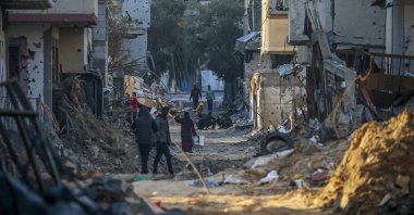 Palestinians walk among the rubble of houses destroyed by Israeli strikes in al-Bureij refugee camp, Gaza Strip, Palestine, Feb. 7, 2024. (EPA Photo)
