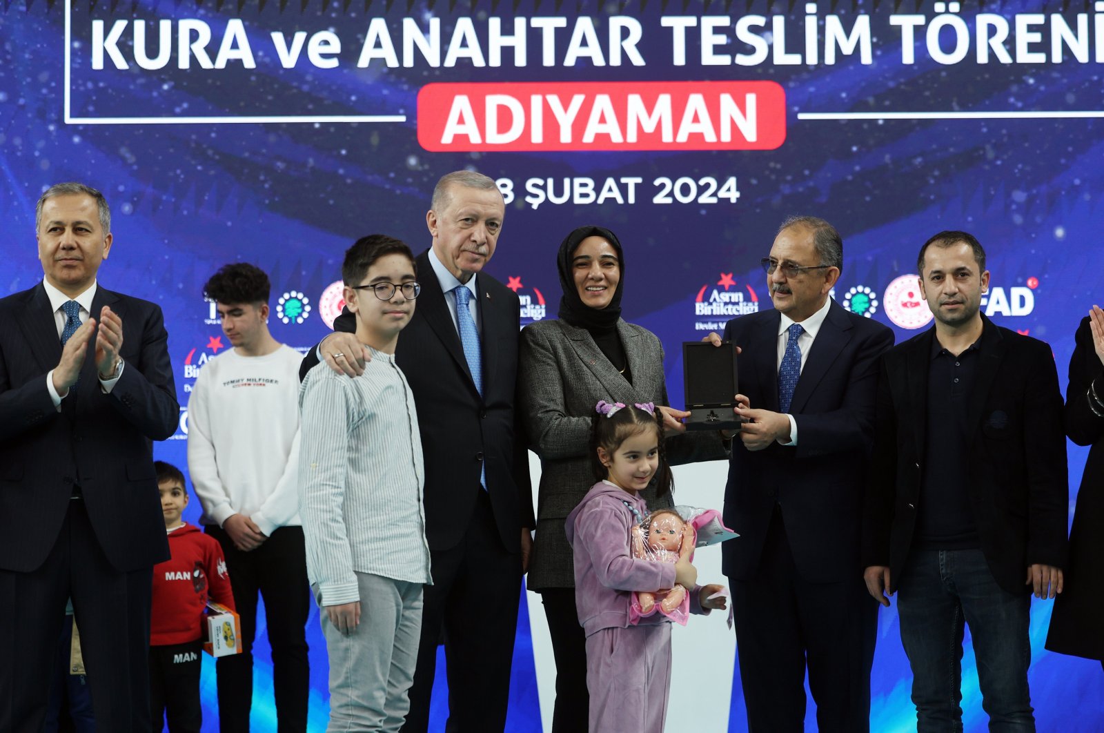 President Recep Tayyip Erdoğan (4th-L) poses with rightful owners as he delivers new homes to earthquake victims in Adıyaman province, southern Türkiye, Feb. 8, 2024. (AA Photo)