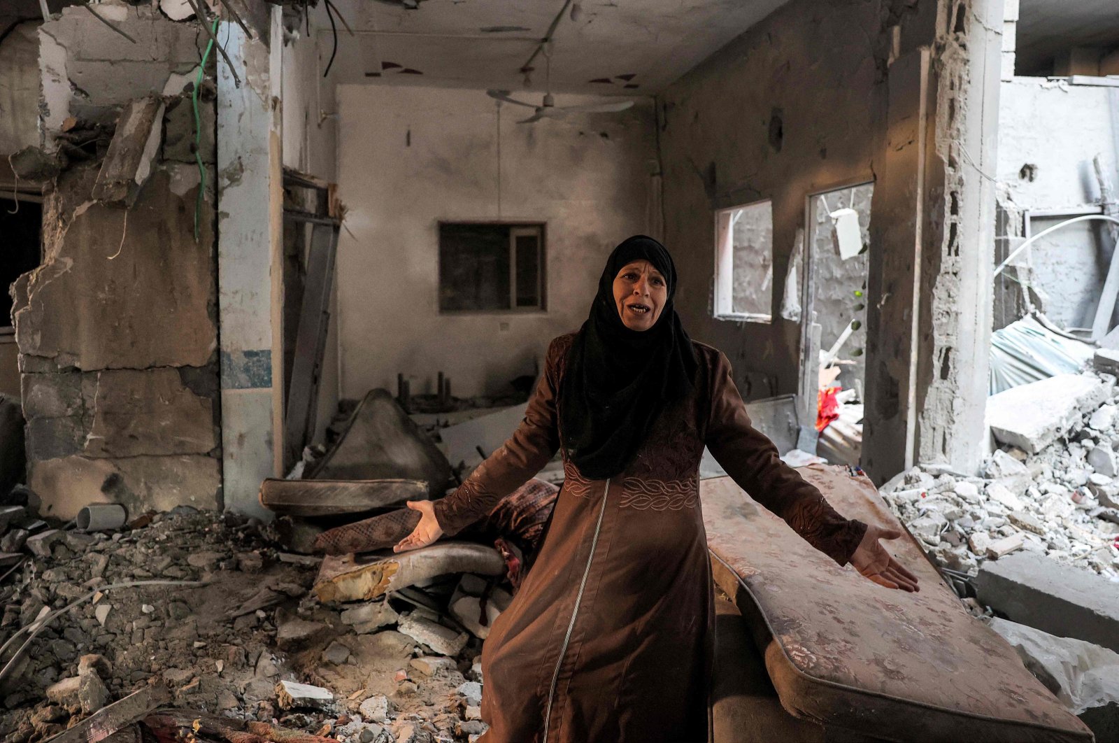 A Palestinian woman cries as she inspects a heavily damaged apartment following Israeli bombardment on Rafah, southern Gaza, Palestine, Feb. 8, 2024. (AFP Photo)