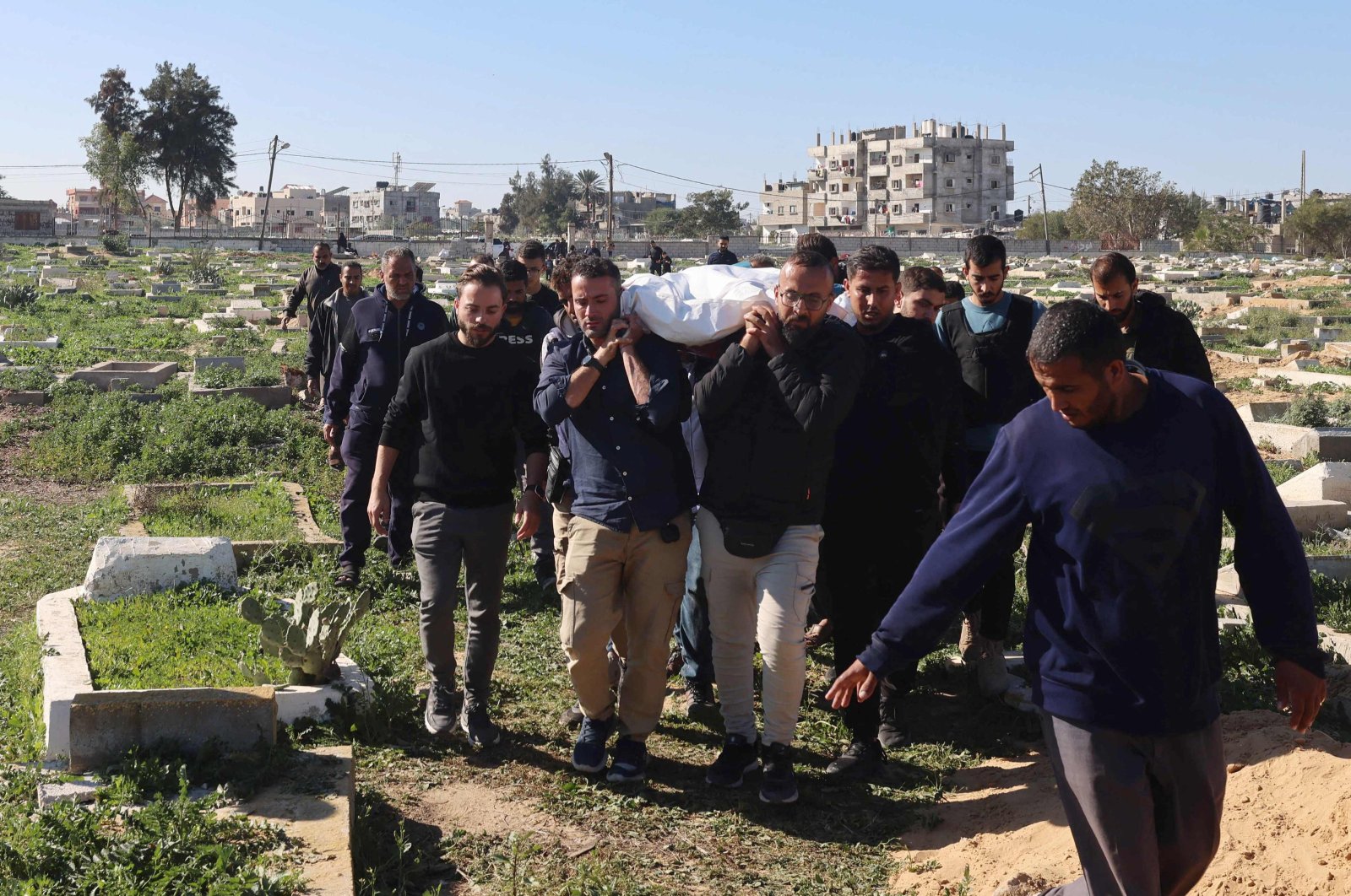 Fellow journalists carry the body of Al Jazeera journalist Hamza Wael Dahdouh during his funeral in Rafah, who was killed in an Israeli airstrike in the Gaza Strip, Palestine, Jan. 7, 2024. (AFP Photo)