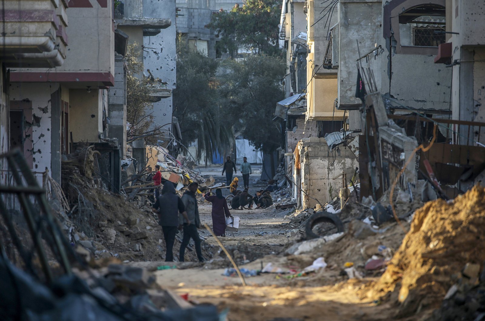 Palestinians walk among the rubble of houses destroyed by Israeli strikes in al-Bureij refugee camp, Gaza Strip, Palestine, Feb. 7, 2024. (EPA Photo)