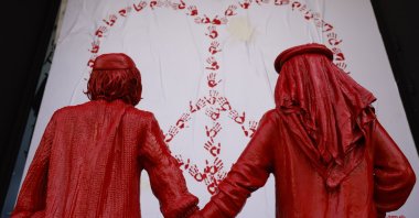 A sculpture by French urban artist James Colomina of an Israeli and a Palestinian boy holding hands in front of a heart with the symbol of peace is on display in a street in Barcelona, Spain, Feb. 8, 2024. (EPA Photo)