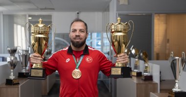 Turkish hearing-impaired wrestler Oğuz Dönder poses with his trophies, Mersin, Türkiye, Feb. 2, 2024. (AA Photo)