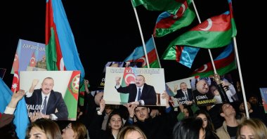 Supporters of Azeri President and presidential candidate Ilham Aliyev rally with national flags and his portraits after polls closed in snap presidential election, Baku, Azerbaijan, Feb. 7, 2024. (AFP Photo)
