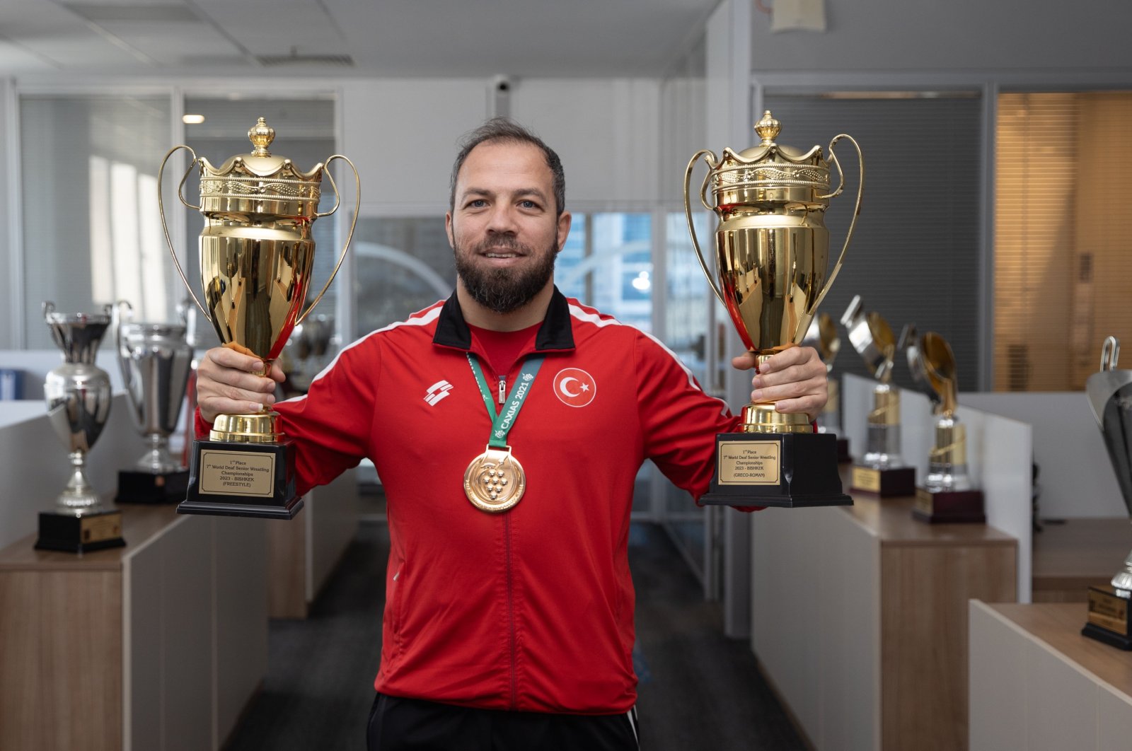 Turkish hearing-impaired wrestler Oğuz Dönder poses with his trophies, Mersin, Türkiye, Feb. 2, 2024. (AA Photo)