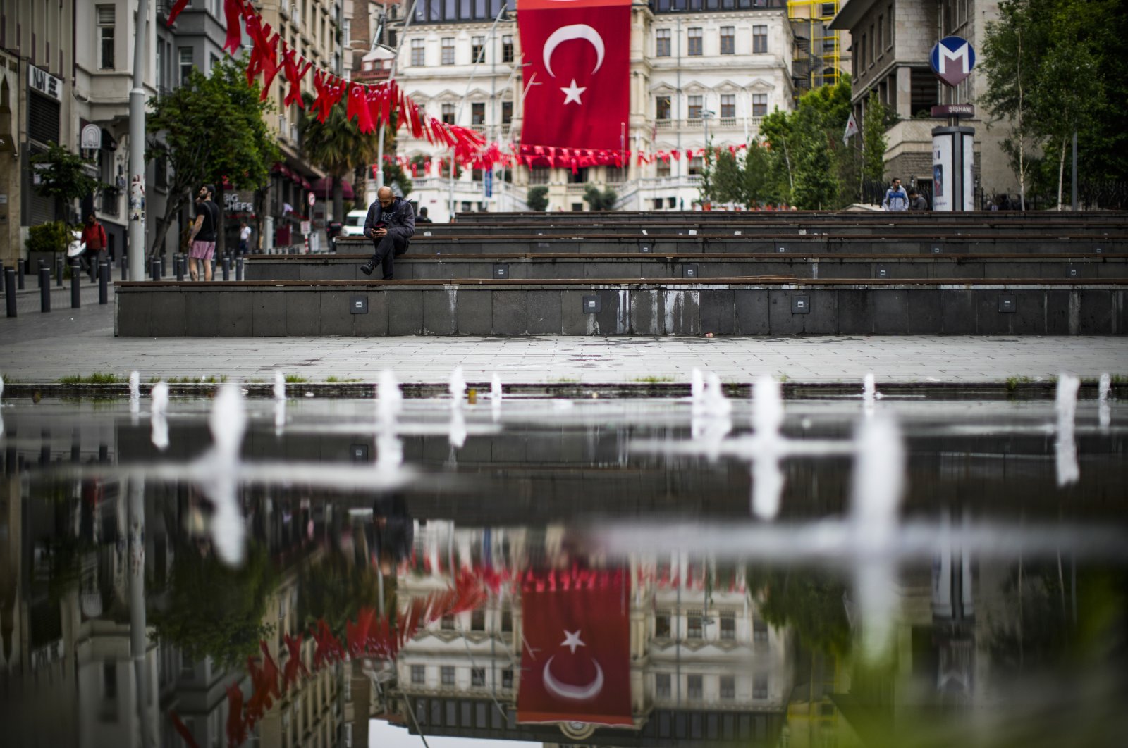A man looks at his seat phone a day after the presidential elections in Istanbul, Türkiye, May 29, 2023. (AP Photo)