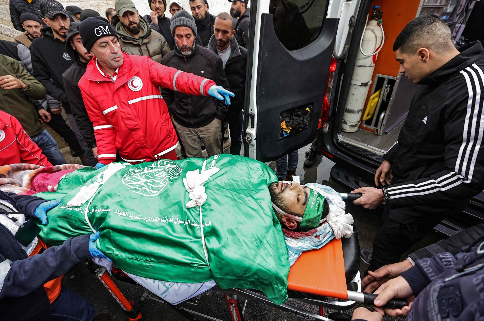 Paramedics transport on a gurney the body of Muhammad Jalamnah, one of three Palestinian men killed when undercover Israeli agents raided the Ibn Sina hospital in the city of Jenin in the occupied West Bank city on Jan. 30, 2024. (AFP Photo)