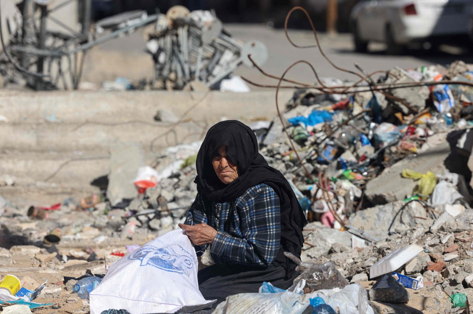 A woman salvages items from the rubble of buildings destroyed by Israeli bombing in Rafah, southern Gaza Strip, Feb. 11, 2024. (AFP Photo)