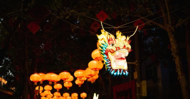 Chinese officials bet on Lunar New Year festivities to boost the economy amid Year of the Dragon celebrations, as migrant workers journey home in adherence to tradition. (Getty Images Photo)
