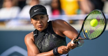 Japan's Naomi Osaka hits a return against Danielle Collins of the U.S. during the women's singles match at the Mubadala Abu Dhabi Open, Abu Dhabi, UAE, Feb. 6, 2024. (AFP Photo)