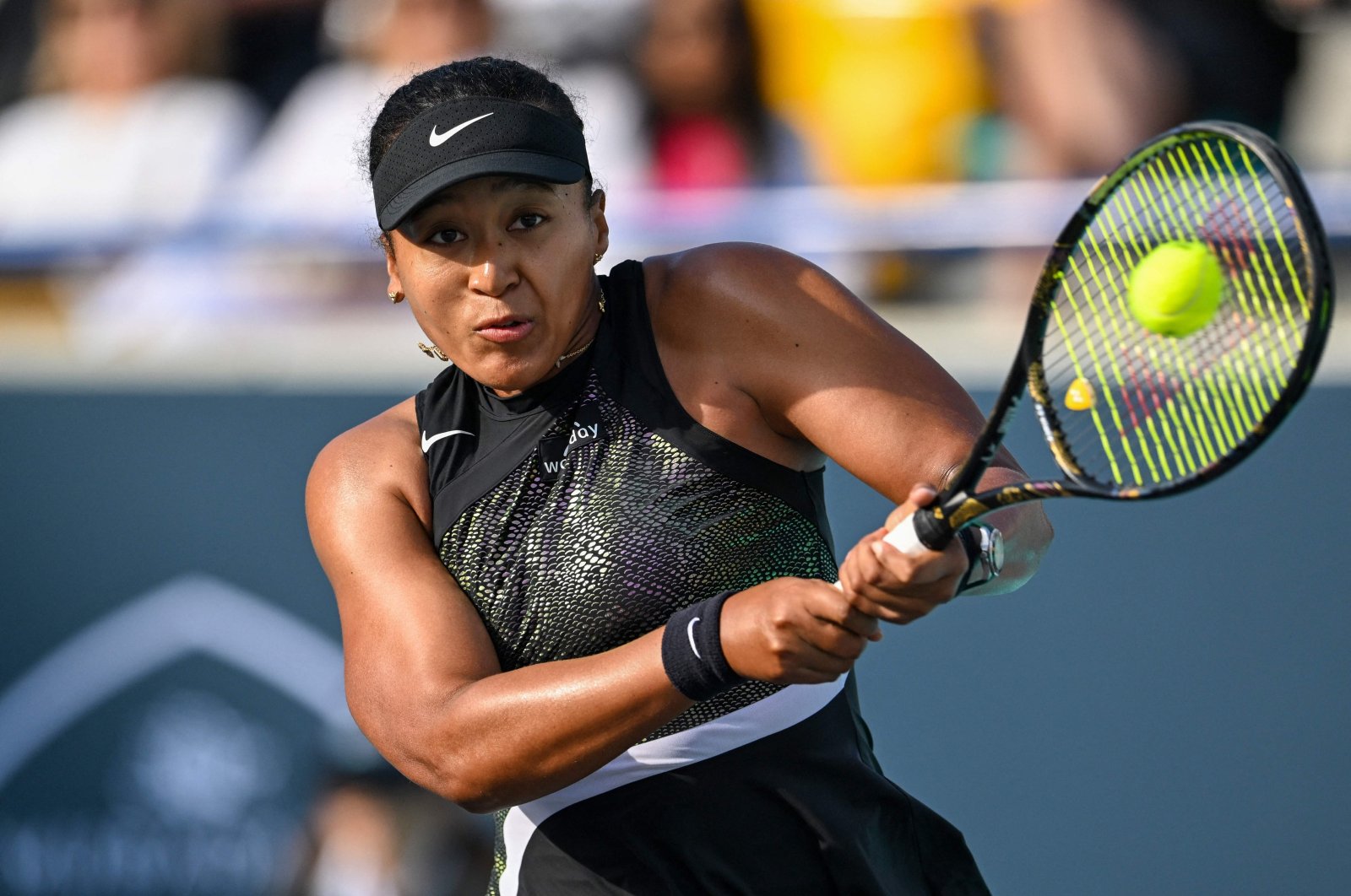 Japan&#039;s Naomi Osaka hits a return against Danielle Collins of the U.S. during the women&#039;s singles match at the Mubadala Abu Dhabi Open, Abu Dhabi, UAE, Feb. 6, 2024. (AFP Photo)