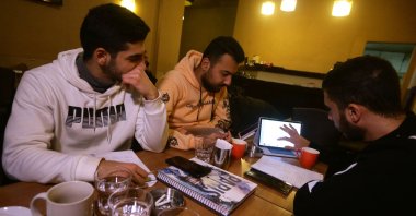 Students study at a cafe in Damascus amid Syria&#039;s infrastructure struggles, where power outages last up to 20 hours a day, turning cafes into co-working spaces. (AFP Photo)