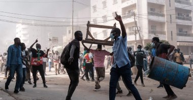 Protesters shout slogans and collect barrels and tables to burn during clashes with police in Dakar, Senegal, Feb. 9, 2024. (AFP Photo)