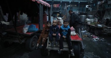 Palestinian children sit at the courtyard of a U.N.-run school and shelter in Gaza, Palestine, Feb. 13, 2024. (AA Photo)