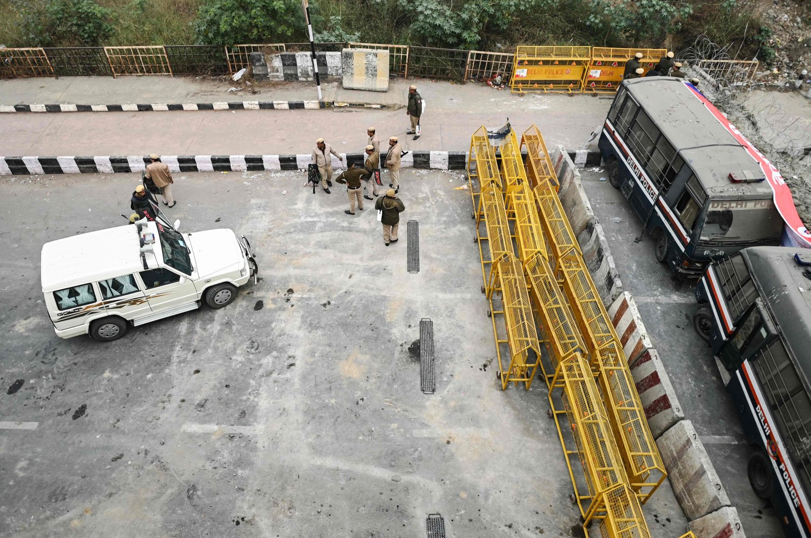 Security personnel stand guard at a road block during a nationwide strike called by farmers, along the Ghazipur New Delhi-Uttar Pradesh state border, India, Feb. 13, 2024. (AFP Photo)