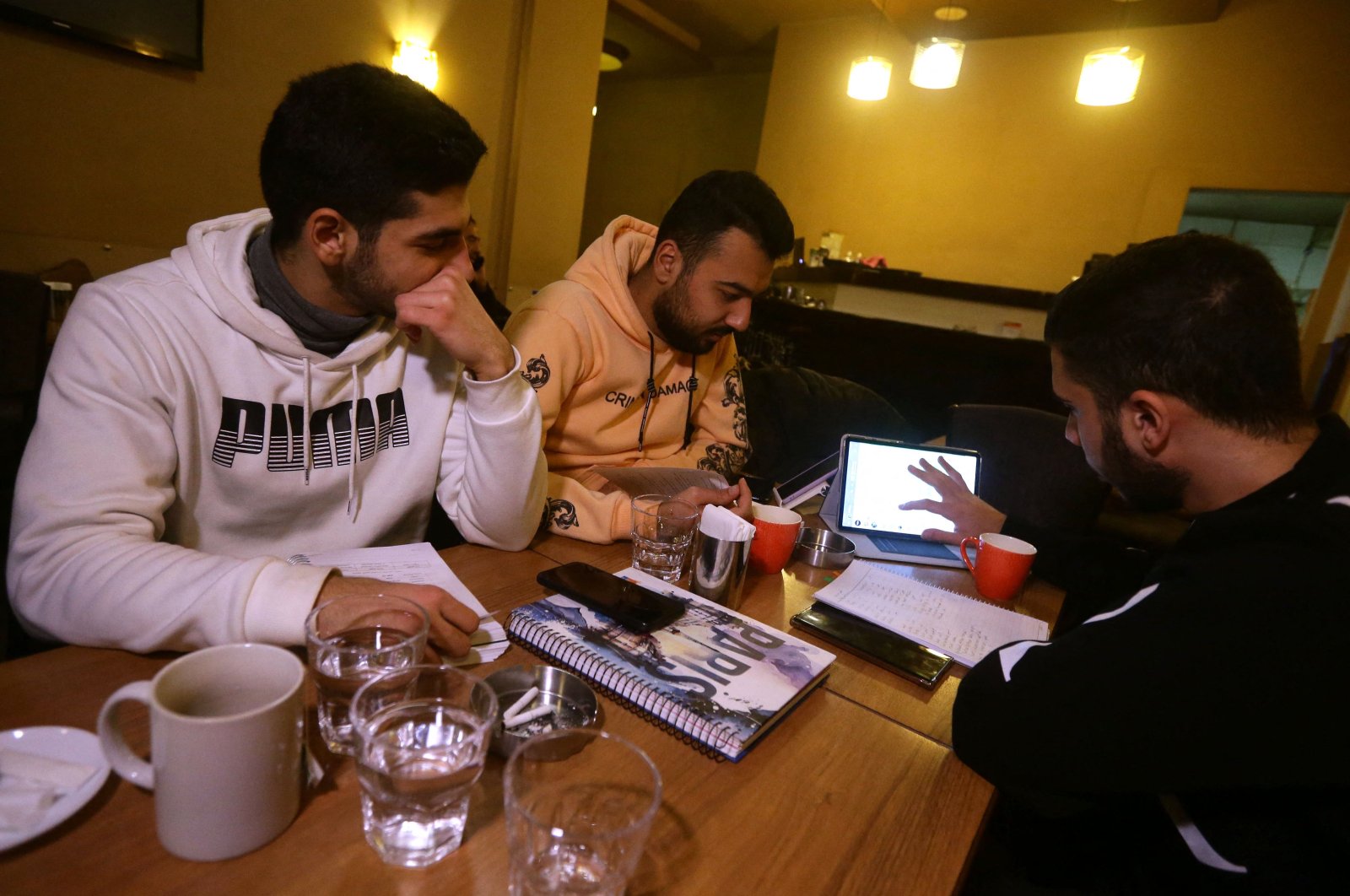 Students study at a cafe in Damascus amid Syria&#039;s infrastructure struggles, where power outages last up to 20 hours a day, turning cafes into co-working spaces. (AFP Photo)