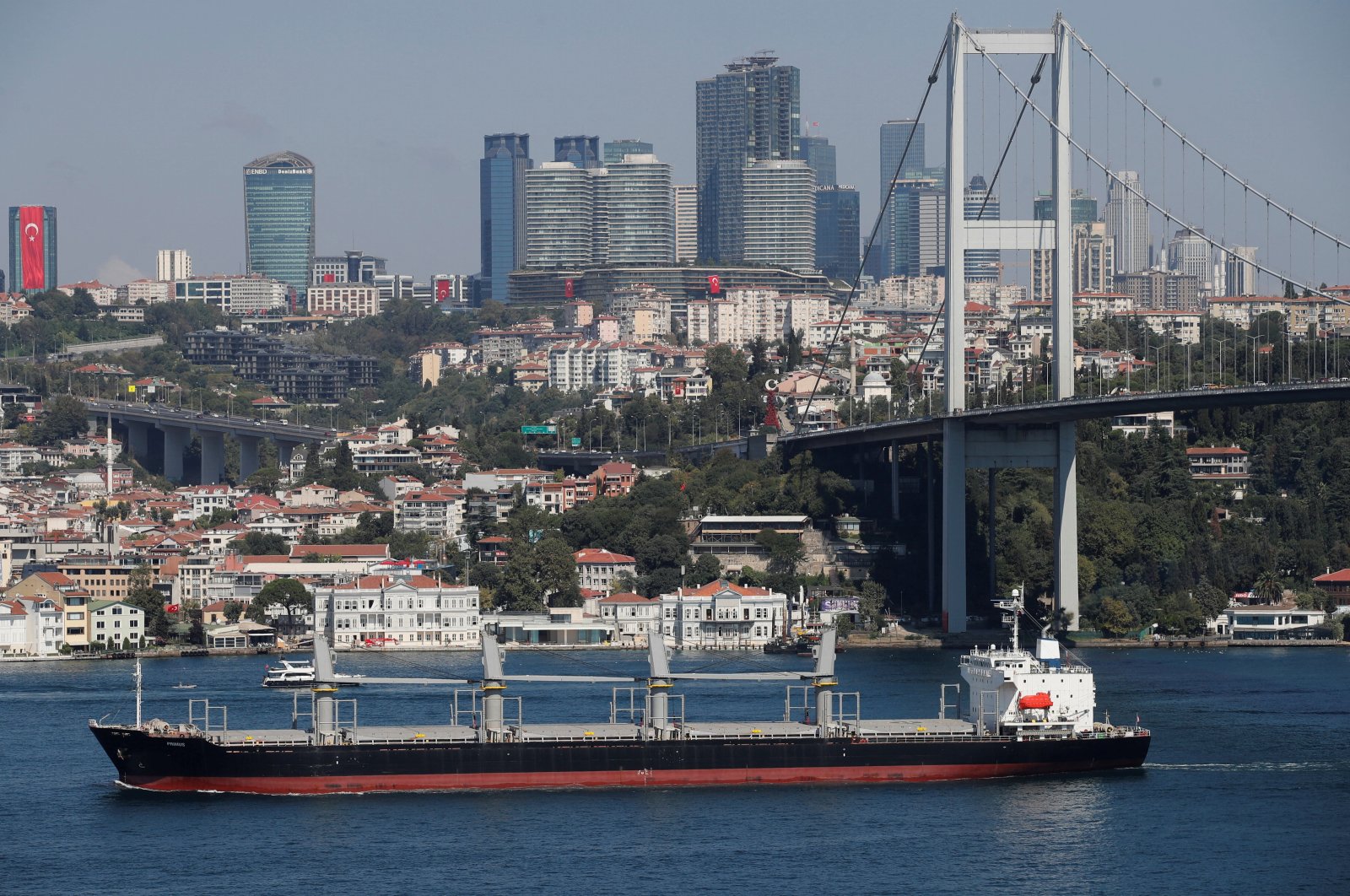 A bulk carrier transits Bosporus with skyscrapers and residential buildings in the background, in Istanbul, Türkiye, Aug. 29, 2023. (Reuters Photo)
