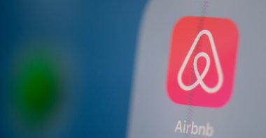 This illustration shows the logo of the U.S. online booking homes application Airbnb on the screen of a tablet, Paris, France, July 24, 2019. (AFP Photo)