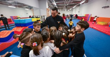 Turkish gymnast Ferhat Arıcan plays with the children at the Göztepe Gymnastics Academy, Istanbul, Türkiye, Feb. 14, 2024. (AA Photo)