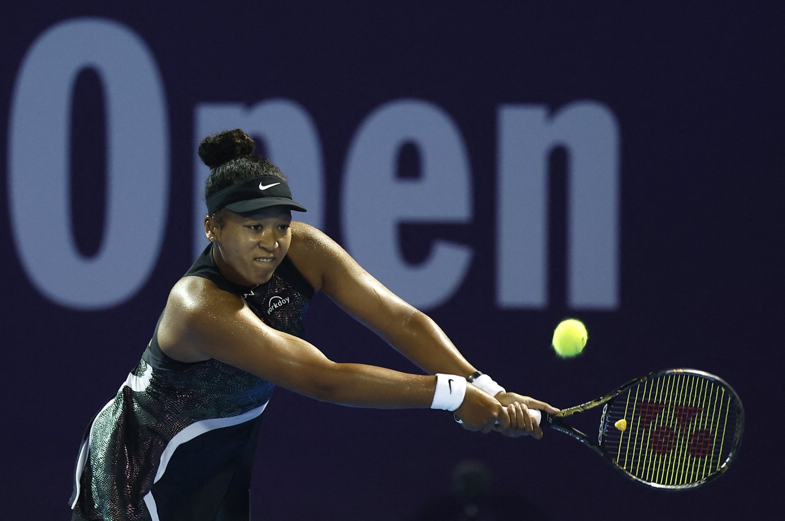 Japan&#039;s Naomi Osaka in action in the round of 32 match against Croatia&#039;s Petra Martic during their women&#039;s singles tennis match at the Qatar WTA Open at Khalifa International Tennis and Squash Complex, Doha, Qatar, Feb. 13, 2024. (AFP Photo)