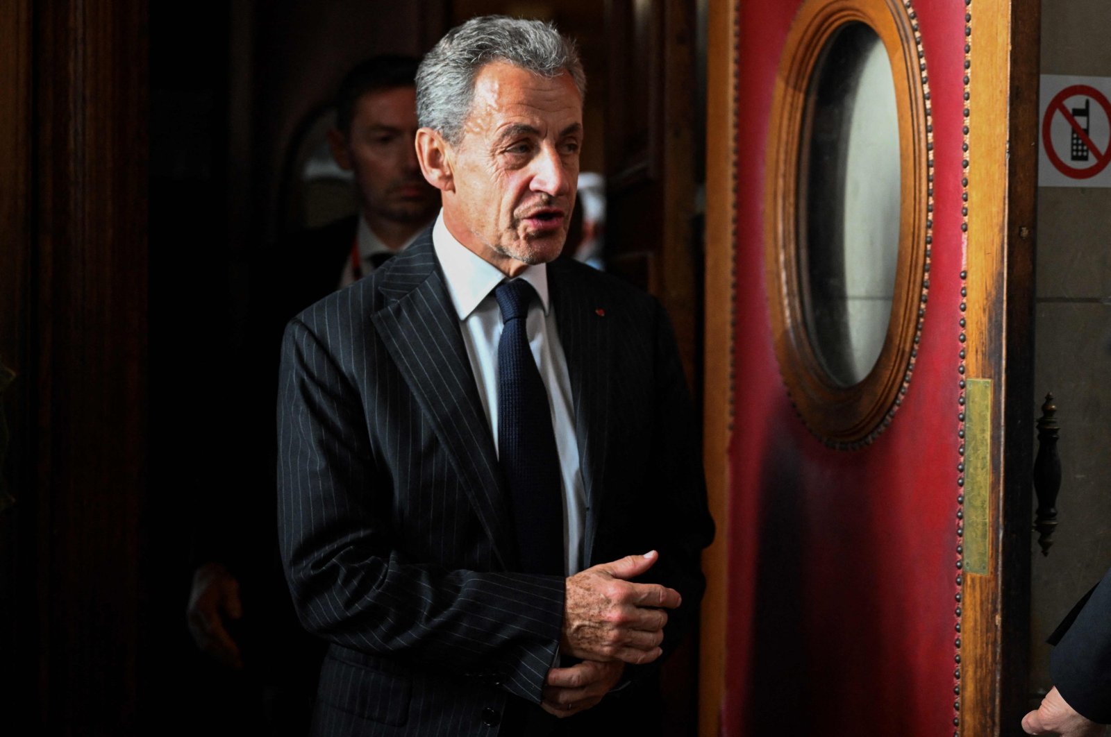 France&#039;s former president Nicolas Sarkozy leaves after the verdict in his appeal trial in the so-called Bygmalion case, at the courthouse, in Paris, on Feb. 14, 2024. (AFP Photo)