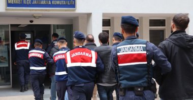 Turkish gendarmerie forces escort nine Gülenist Terror Group (FETÖ) suspects caught on the border in the northwestern Edirne province while trying to flee abroad, Türkiye, Feb. 5, 2024. (AA Photo)