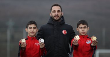 Turkish twin athletes Muhammet Emir (L) and Yasin Emir Güneş (R) pose for a photo with their uncle Mustafa Güneş, Duzce, Türkiye, Feb. 15, 2024. (AA Photo)
