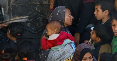 Palestinian women and children wait to receive food, in Rafah, southern Gaza Strip, Palestine, Feb. 15, 2024. (Reuters Photo)