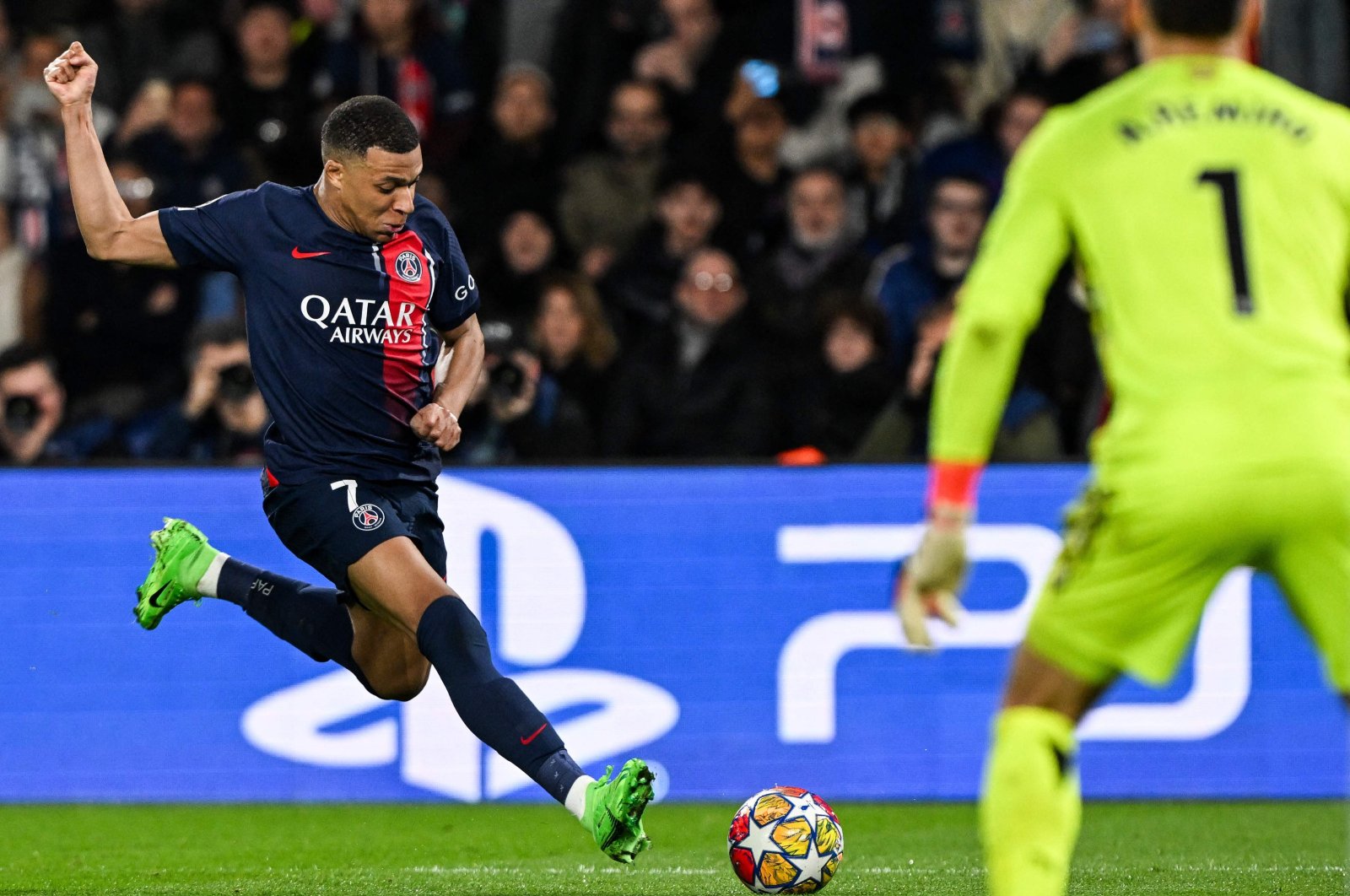 PSG&#039;s Kylian Mbappe (L) kicks the ball next to Real Sociedad&#039;s Alex Remiro during the UEFA Champions League round of 16 first leg football match at the Parc des Princes Stadium, Paris, France, Feb. 14, 2024. (AFP Photo)