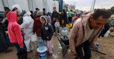 People line up to fill their containers with water amid ongoing Israeli attacks in Rafah on the southern Gaza Strip, Palestine, Feb. 15, 2024. (AFP Photo)
