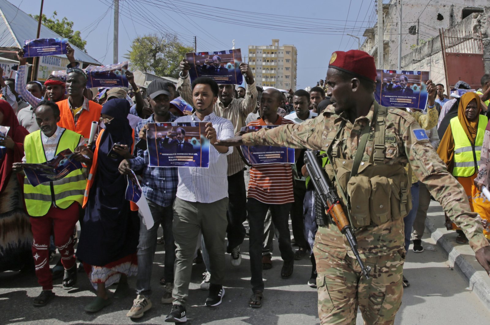A Somali soldier controls the crowd as thousands of people attend a protest rally in Mogadishu, Somalia, Jan.3, 2024. (AP Photo)