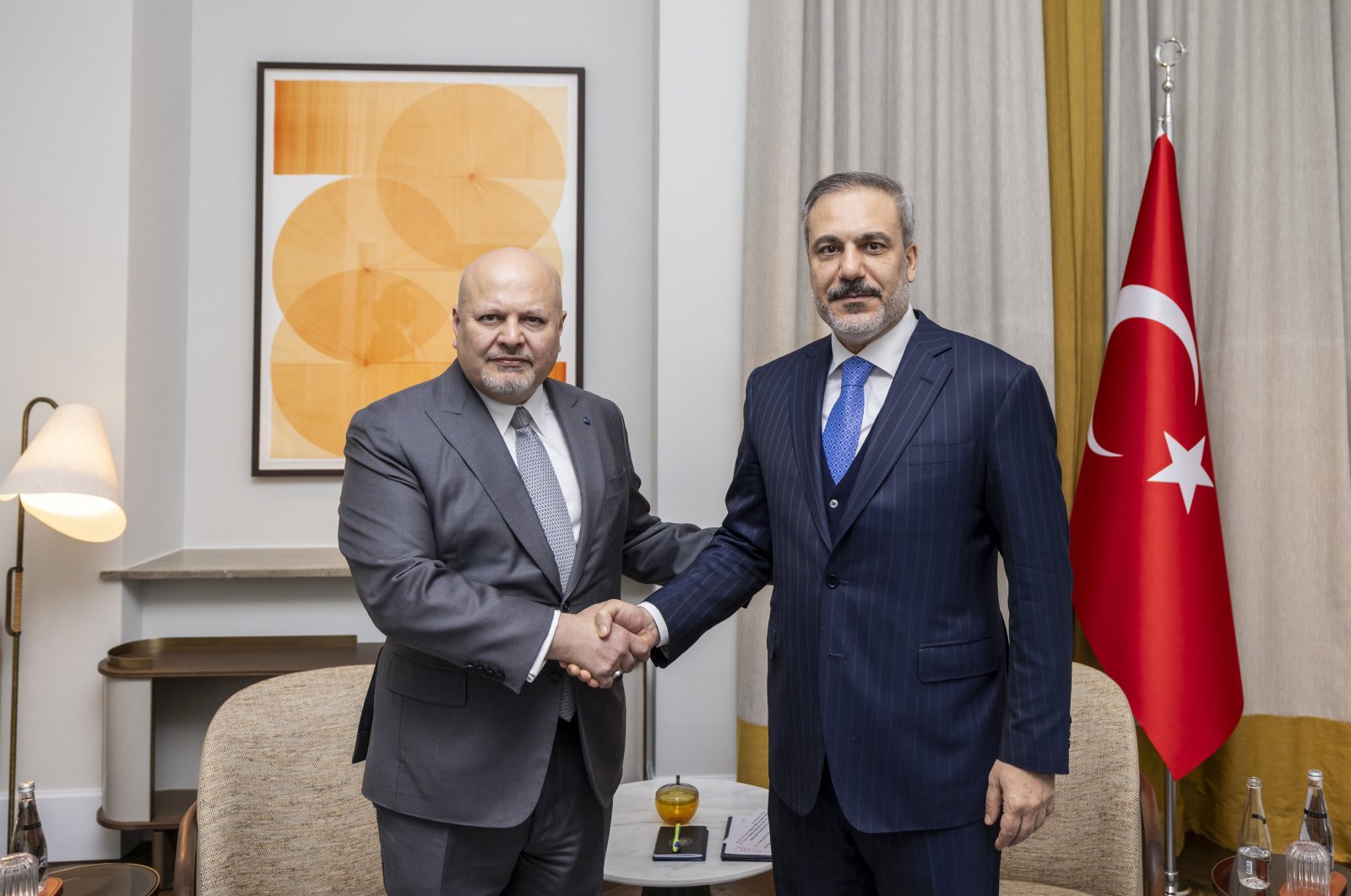 Foreign Minister Hakan Fidan (R) shakes hands with International Criminal Court (ICC) Chief Prosecutor Karim Khan during their meeting, Munich, Germany, Feb. 17, 2024. (AA Photo)