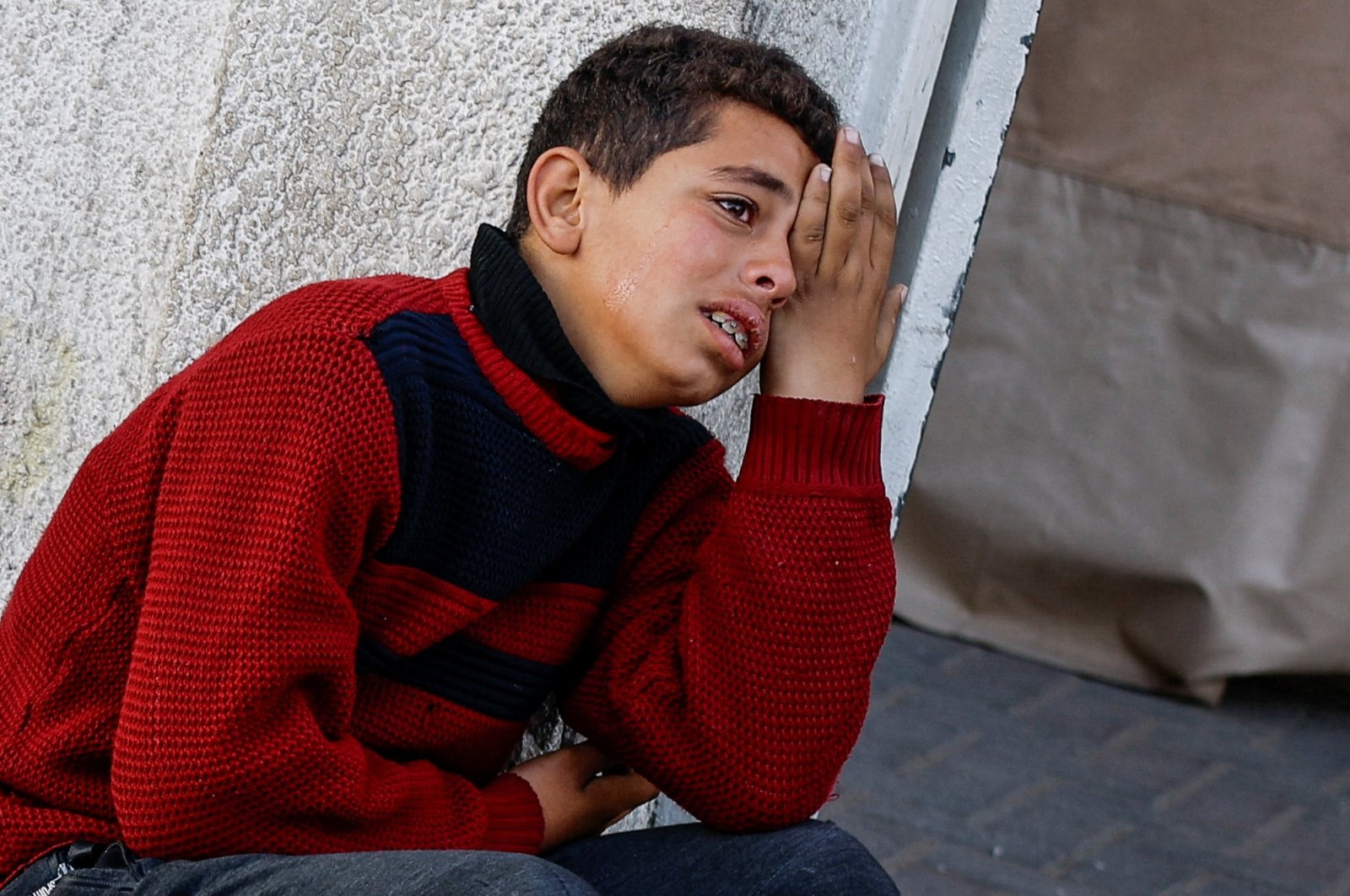 A boy mourns the death of his loved ones in Israeli attacks on Rafah, southern Gaza Strip, Palestine, Feb. 18, 2024. (Reuters Photo)