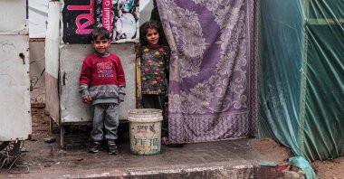 Displaced Palestinian children stand in front of a tent in Rafah, southern Gaza Strip, Feb. 18, 2024. (AFP Photo)