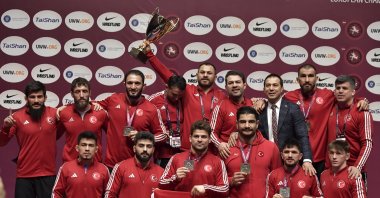 The Turkish wrestling team celebrates with their trophy after dominating the European Championships, Bucharest, Romania, Feb. 18, 2024. (AA Photo)