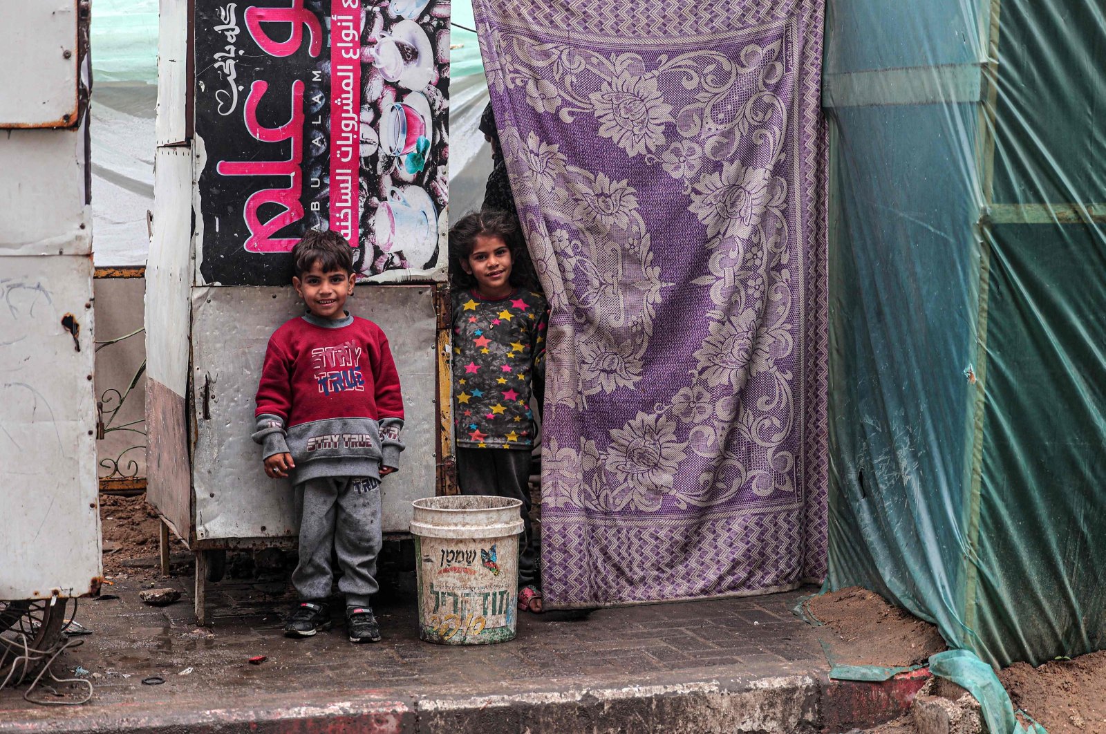 Displaced Palestinian children stand in front of a tent in Rafah, southern Gaza Strip, Feb. 18, 2024. (AFP Photo)
