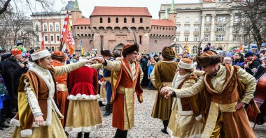 Participants of a procession dance the polonaise in front of the Florianska gate, Krakow, Poland, Jan. 6, 2023. (Getty Images Photo)