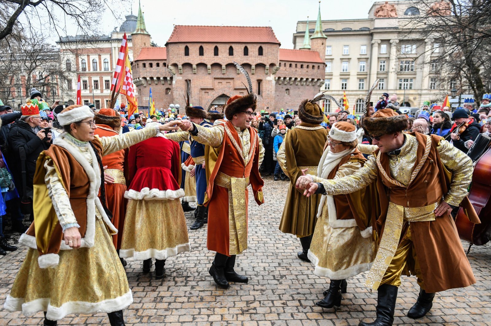 Participants of a procession dance the polonaise in front of the Florianska gate, Krakow, Poland, Jan. 6, 2023. (Getty Images Photo)