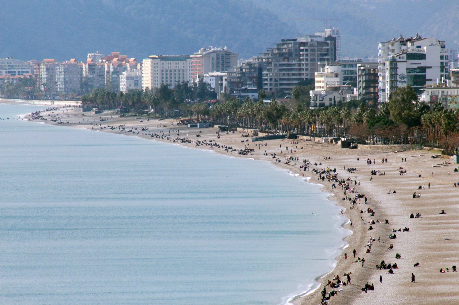 Aerial view of groups of people enjoying warm weather at a beach in Antalya, southern Türkiye, Feb. 18, 2024. (DHA Photo)