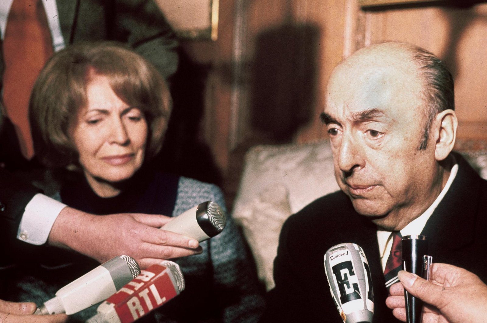 Chilean writer, poet and diplomat, Pablo Neruda, then ambassador to France, answers journalists&#039; questions on Oct. 21, 1971, next to his wife at the Chilean Embassy in Paris after being awarded the 1971 Nobel Literature Prize. (AFP Photo)