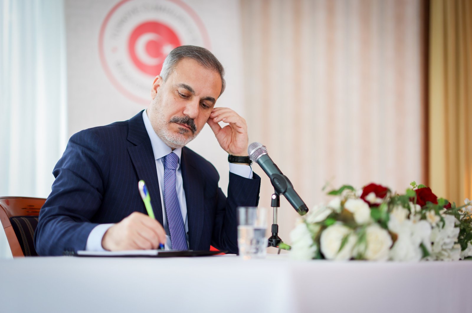 Foreign Minister Hakan Fidan takes notes as he meets with representatives of nongovernmental organizations (NGOs) on the margins of Munich Security Conference at the Turkish Consulate General, Munich, Germany, Feb. 18, 2024. (AA Photo)