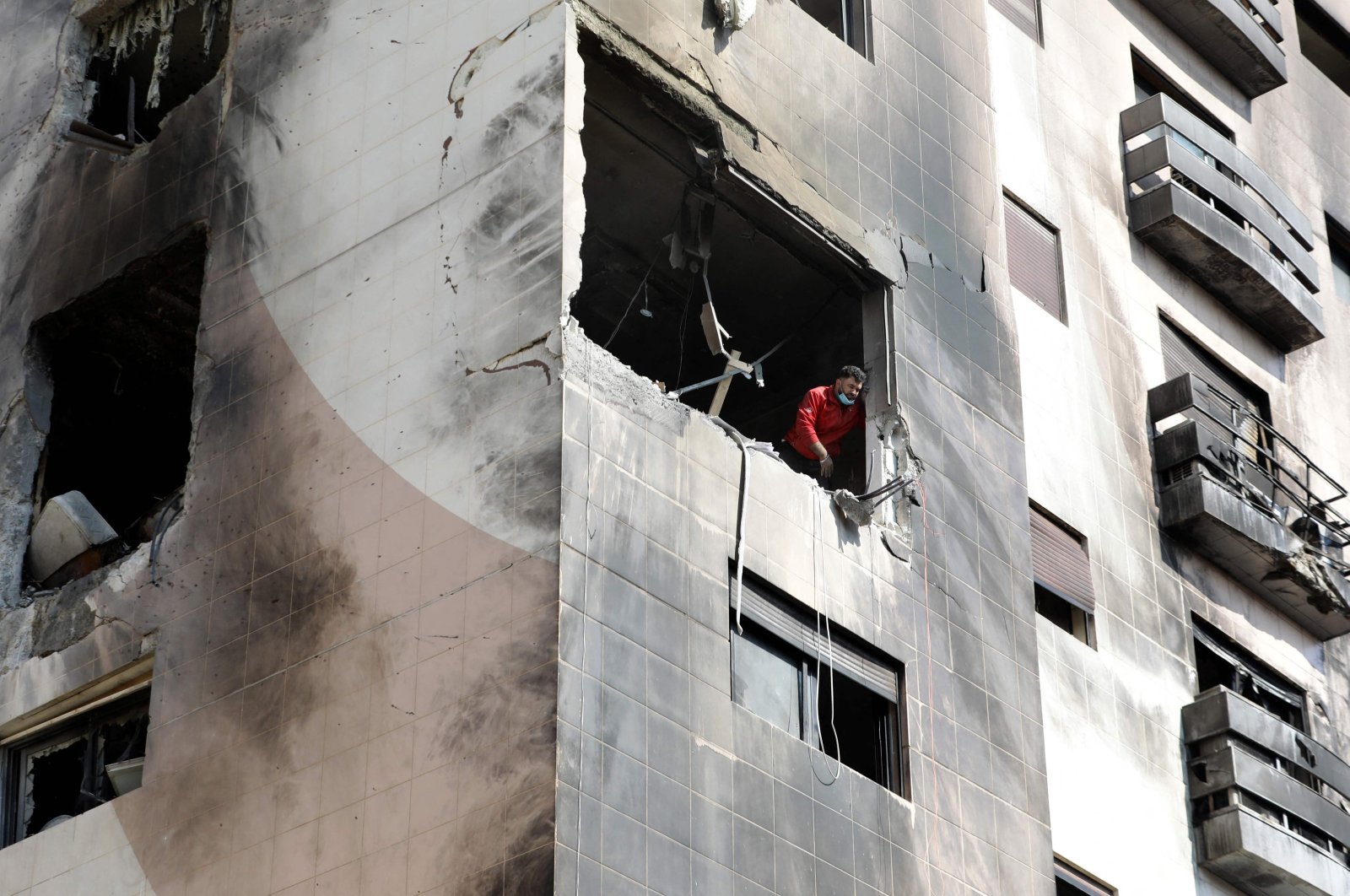 A man checks the damage in an apartment in a residential building targeted by Israeli airstrikes, Damascus, Syria, Feb. 21, 2024. (AFP Photo)