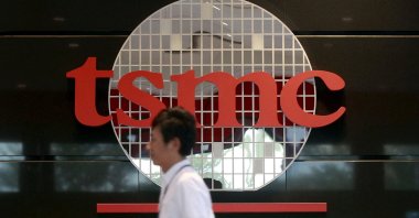 An employee walks in front of the logo of Taiwan Semiconductor Manufacturing Company (TSMC) at its headquarters in Hsinchu, northern Taiwan, Nov. 19, 2015. (Reuters Photo)