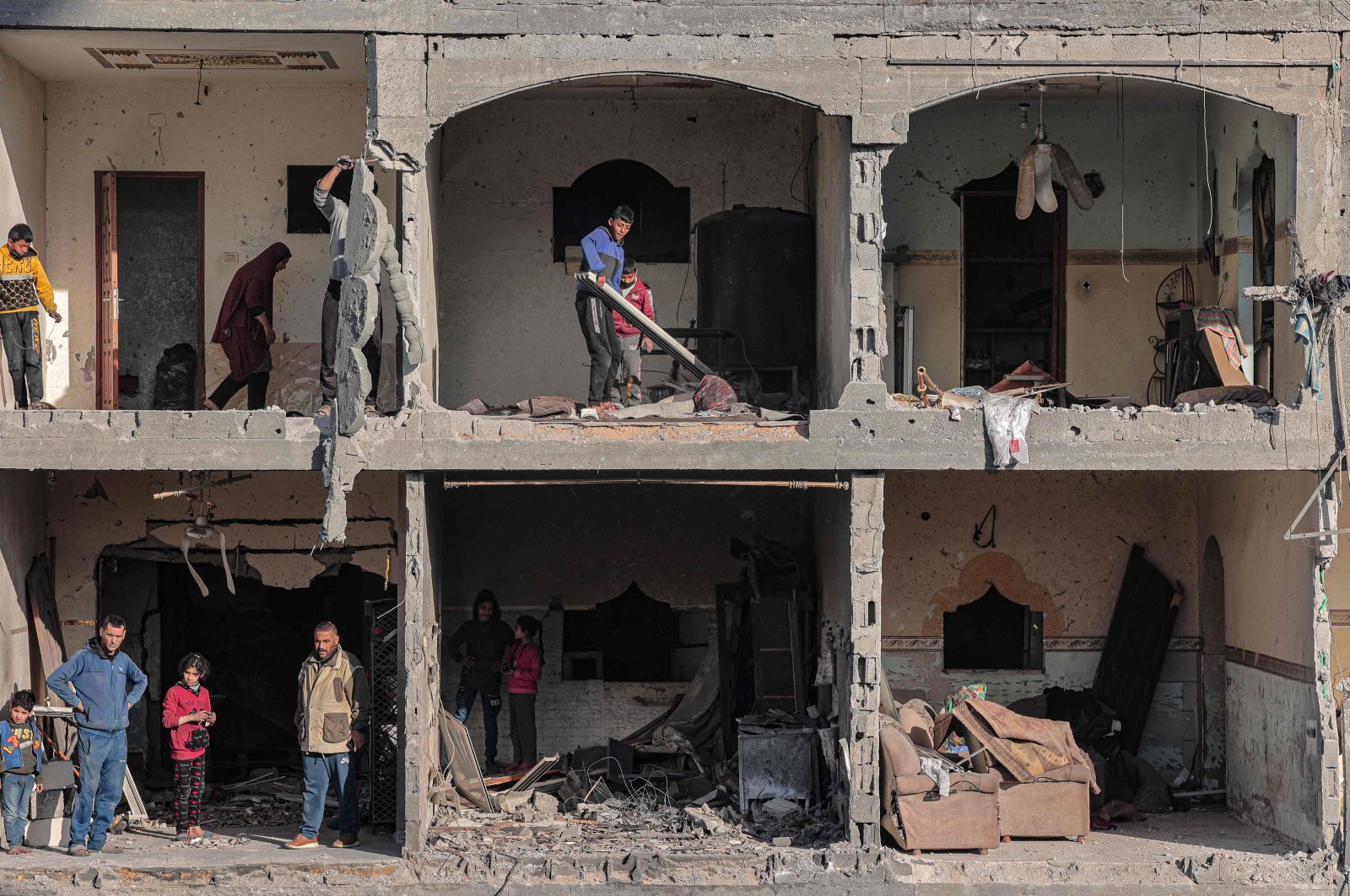 People check the debris at a building destroyed by an Israeli airstrike, Gaza, Palestine, Feb. 22, 2024. (AFP Photo)