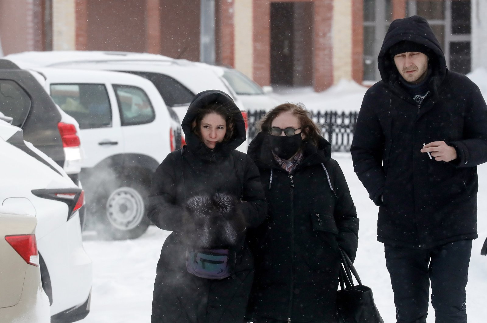 Lyudmila Navalnaya (C), the mother of Alexei Navalny, walks accompanied by lawyers after visiting the Investigative Committee in Salekhard, Yamalo-Nenets region, Russia, Feb. 19, 2024. (EPA Photo)