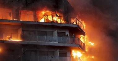 Two people wait to be rescued from a fire at a 14-story residential building in Valencia, Spain, Feb. 22, 2024. (EPA Photo)