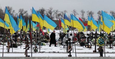 An elderly woman walks among the graves along the Alley of Heroes where Ukrainian soldiers who died in the Russian-Ukrainian war are buried, in Kramatorsk, Donetsk region, Ukraine, Feb. 22, 2024. (AFP Photo)